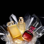 Generic perfume bottles in a gift set on black background